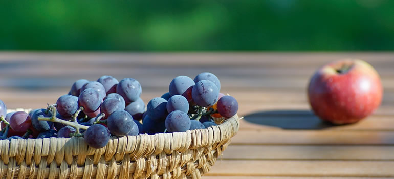 grapes and apple on table