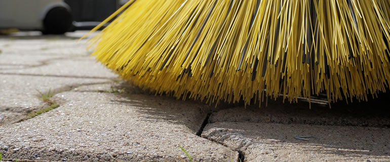 close up of brush on block paving